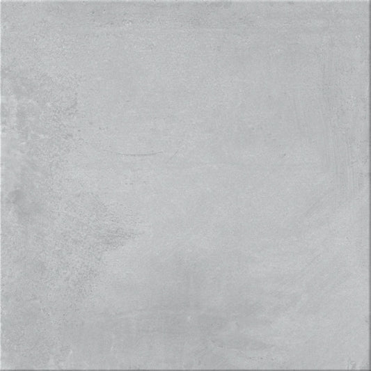 Pavimento cerâmico Dominó Newstreet Fog Eco 60x60cm visto em pormenor, mostrando a textura de efeito cimento cinza claro.