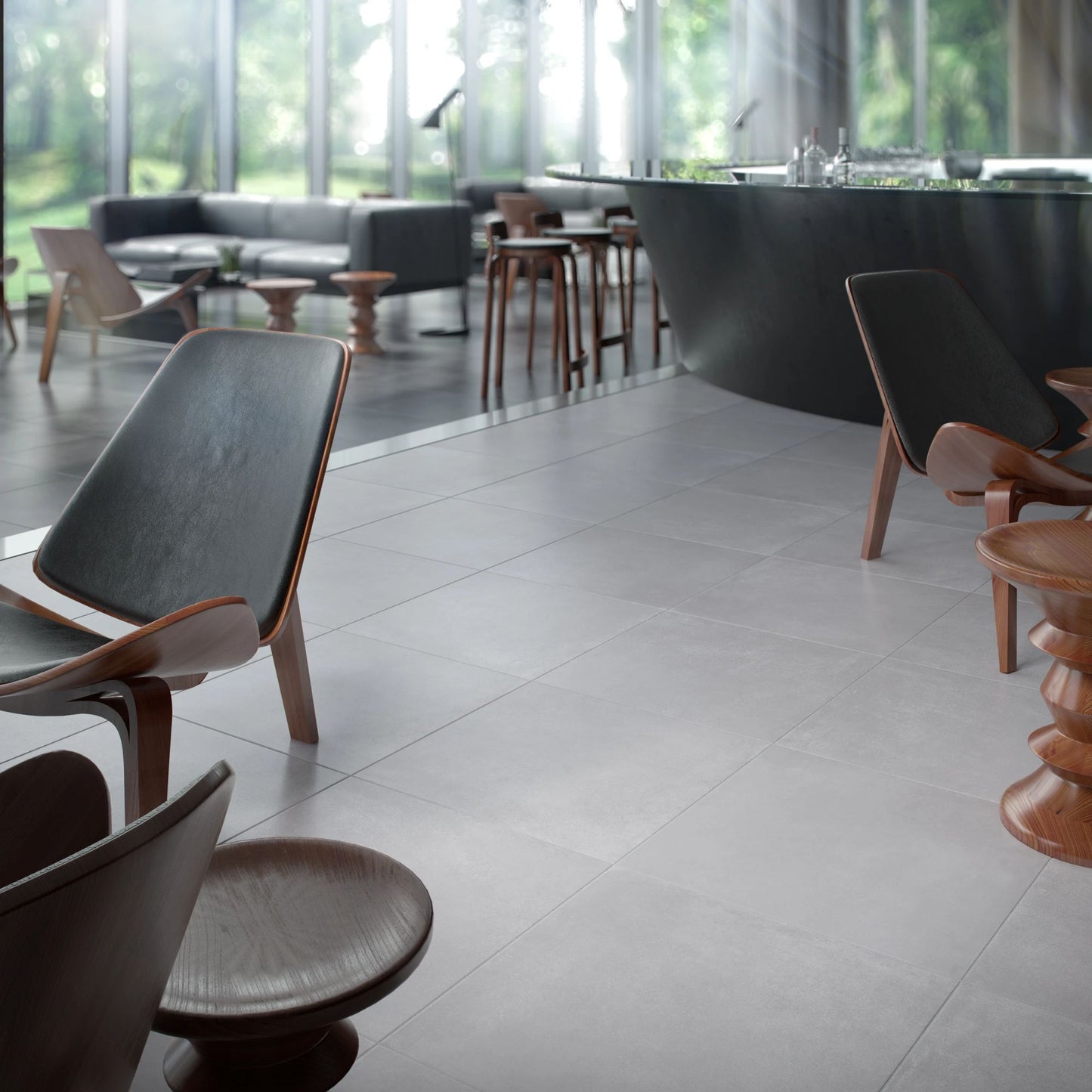 Espaço lounge contemporâneo com cadeiras de design e chão em pavimento cerâmico Dominó Urban Light Grey