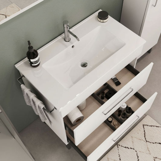 Lavatório Fifty 81 cm branco instalado sobre móvel de casa de banho com gavetas abertas.