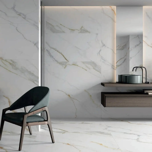 alt text= 'Pavimento e revestimento cerâmico Supreme Calacata 60x120 cm aplicado numa casa de banho moderna, com veios dourados e cinzentos'