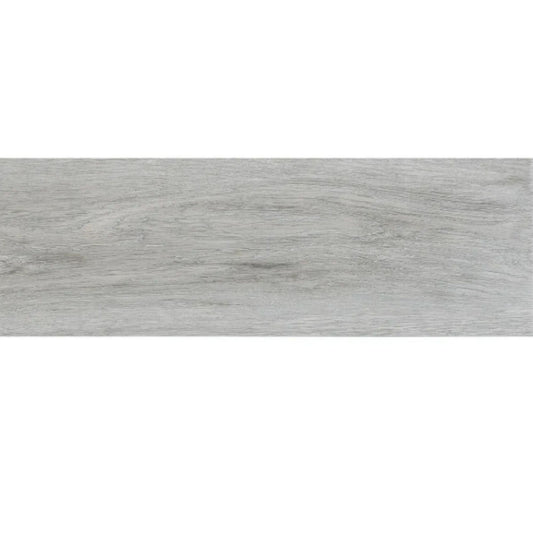 alt='Peça de pavimento cerâmico retangular Forest Argent Gris com acabamento a imitar madeira em tons de cinza.'