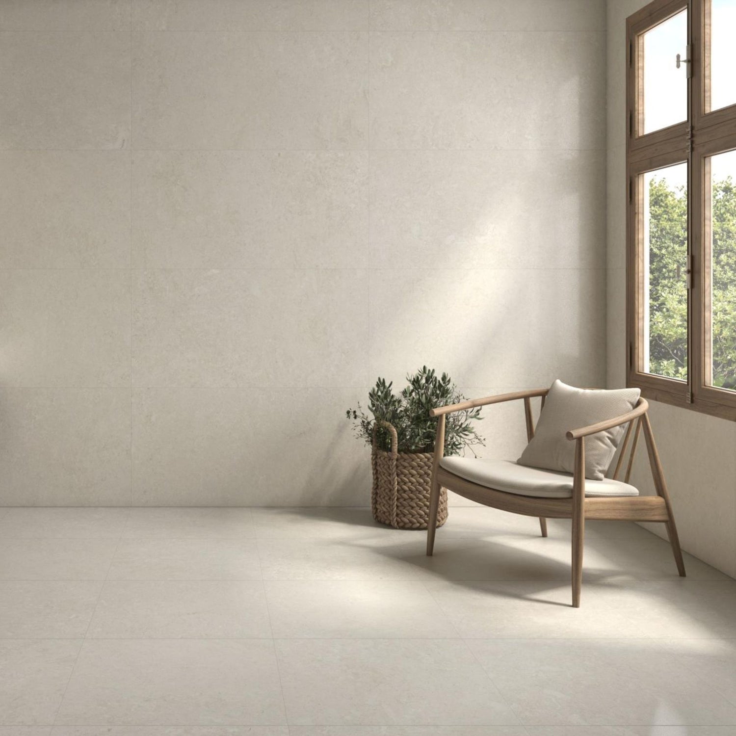 Detalhe de pavimento Coralstone Marfil Mate 60x120 aplicado em sala de estar iluminada com decoração minimalista.